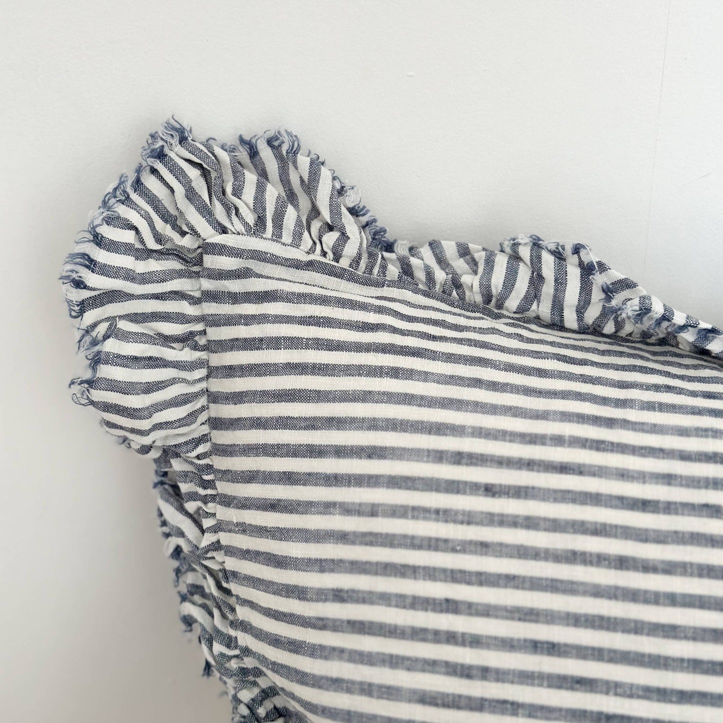 Striped fabric with ruffled edge on a white background