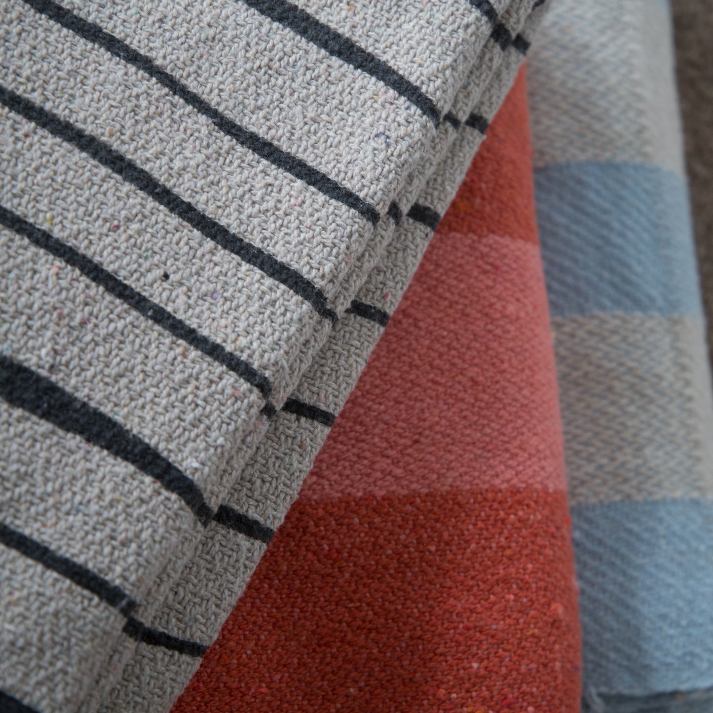 Set of three Bloomingville Recycled Cotton Throws placed on top of each other.