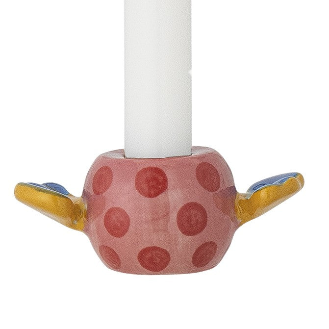 Ceramic candle holder with polka dot design on a white background