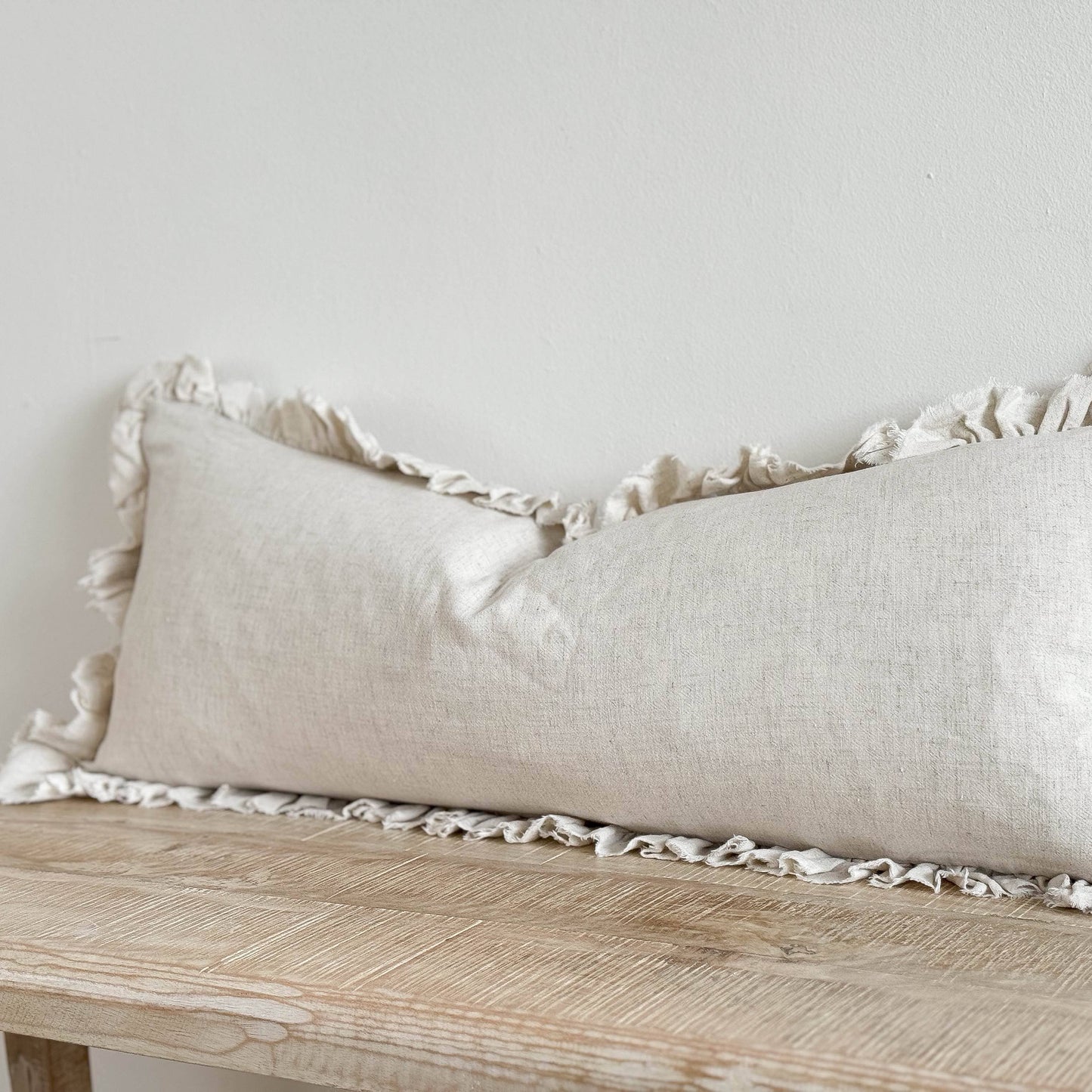 Ellenvale Grace Linen Blend Cushion Cover in Sand Colour. This cushion is a bolster cushion with a ruffled edge and comes with the option of an eco-friendly cushion filler.