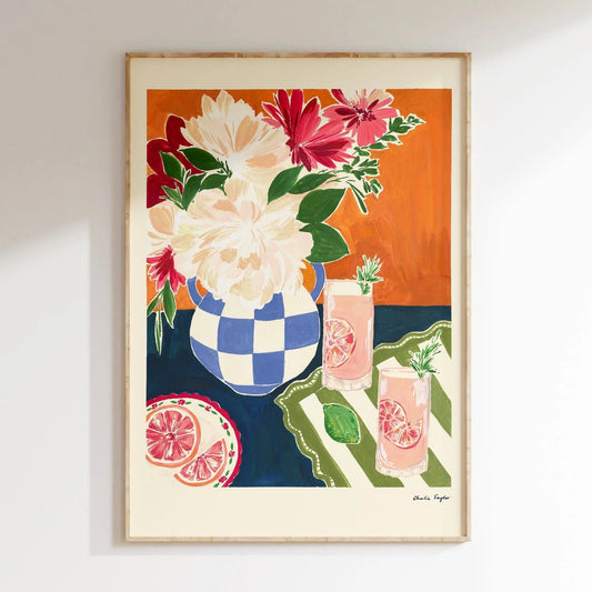 Framed artwork of a floral and fruit scene on an orange background