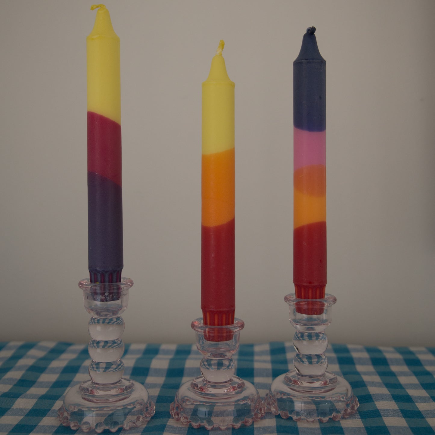 Nordtrice Summer Colours Tapered Candles displayed in pink glass candle holders
