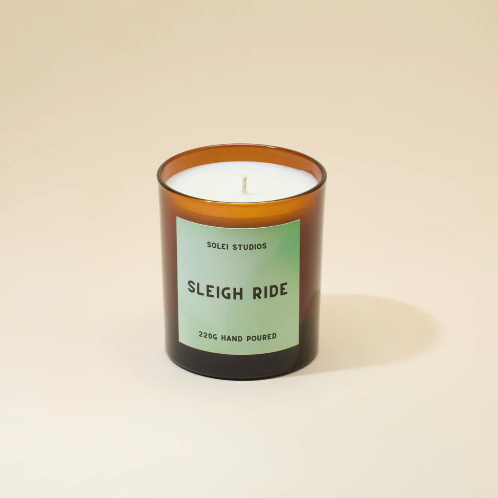 Candle with a green label on a beige background