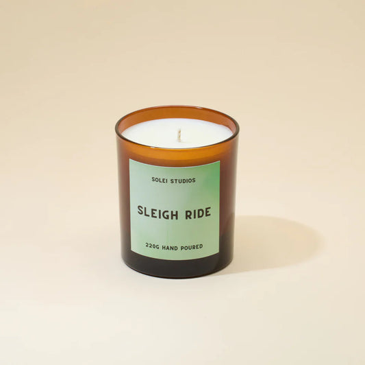 Candle with a green label on a beige background