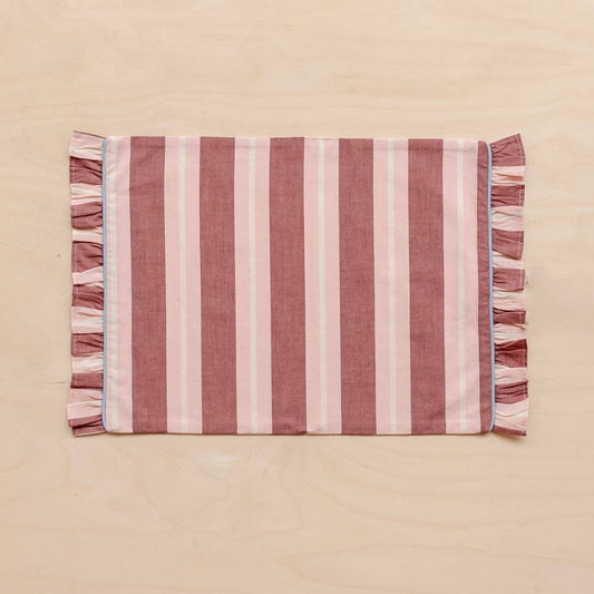 TBCo Cotton Placemats in Red and Pink Stripe with Frilly Edge laid flat on a pink background.