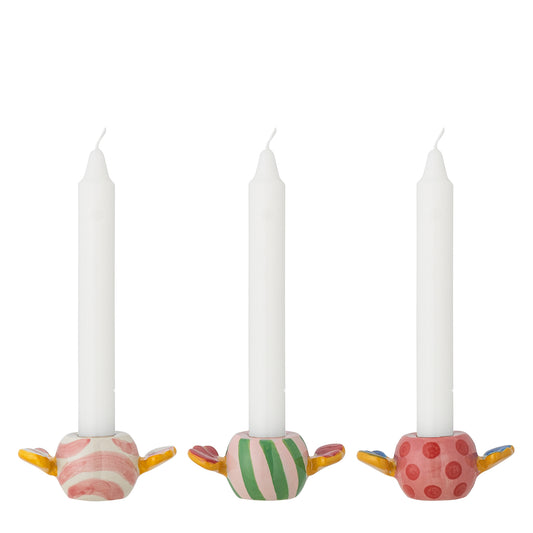 Three decorative candle holders with candles on a white background