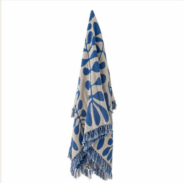 Blue and beige patterned throw with fringes on a white background