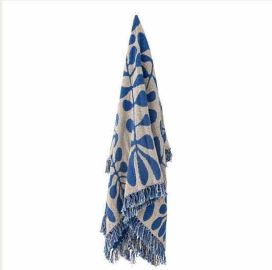 Blue and beige patterned throw with fringes on a white background