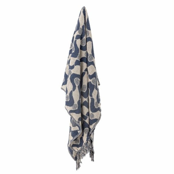 Folded throw with blue and beige pattern on a white background