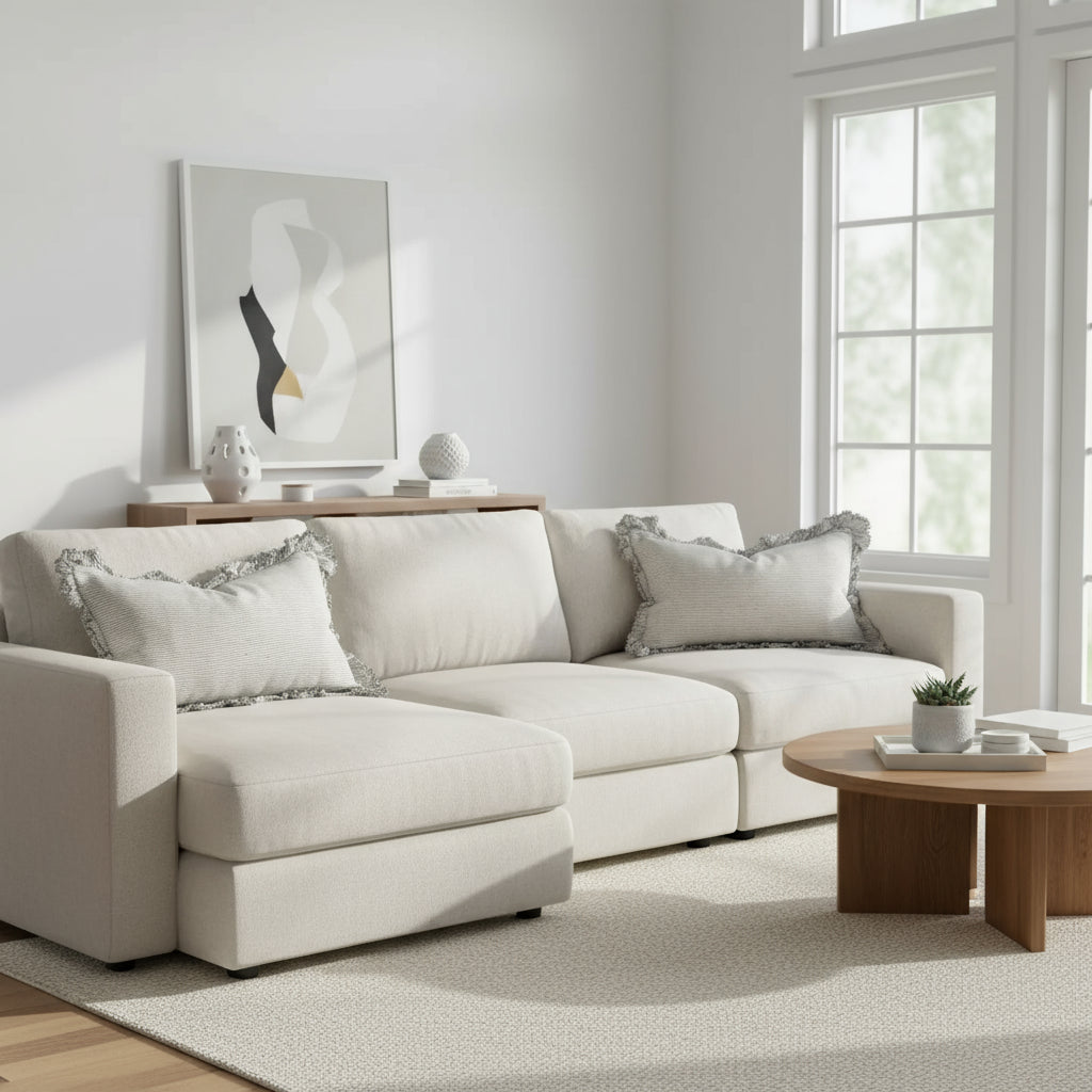 Striped pillow with ruffled edges on a wooden surface against a white wall