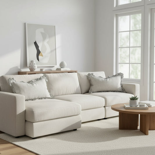 Striped pillow with ruffled edges on a wooden surface against a white wall