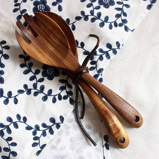 Wooden salad servers on a floral-patterned cloth