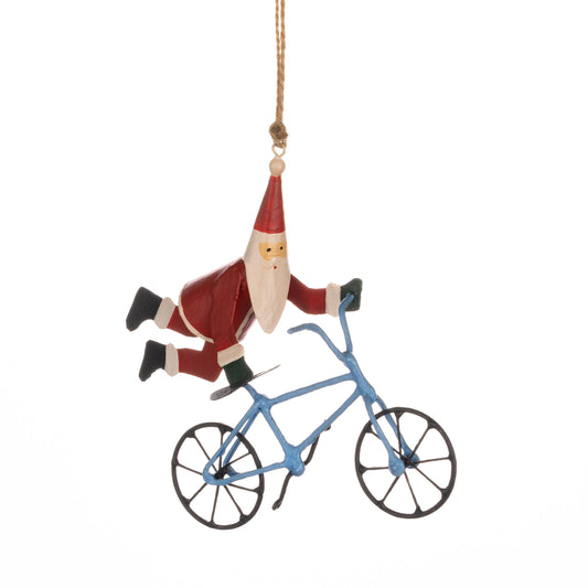 Decorative ornament of a Santa Claus riding a blue bicycle on a white background