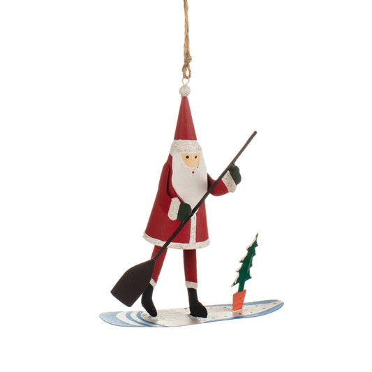 Decorative ornament of Santa Claus skiing with a carrot and green tree, hanging from a string.