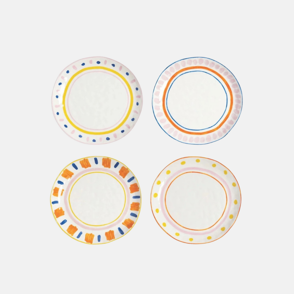 Four decorative plates with colorful rim designs on a white background