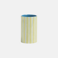Striped ceramic tumbler with blue interior on a white background
