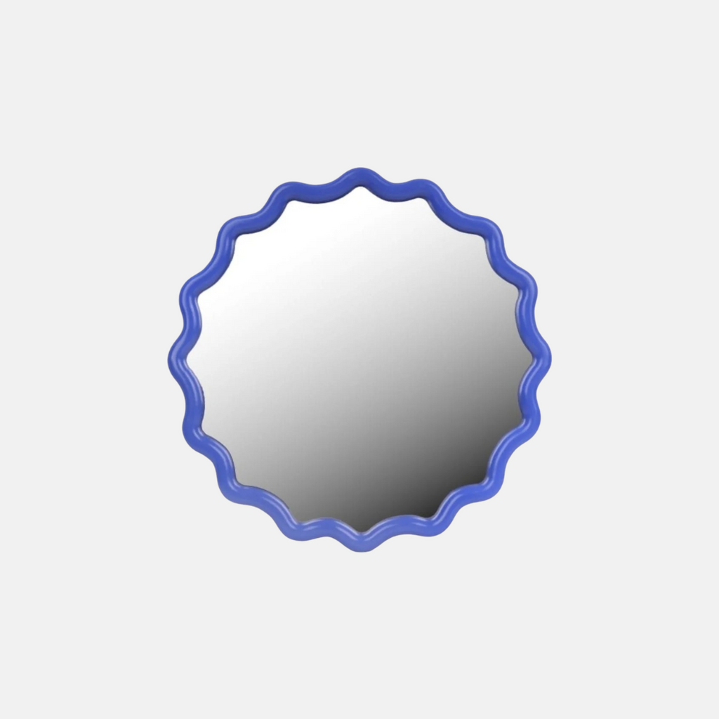 Round mirror with a blue scalloped frame on a light gray background