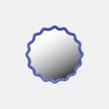Round mirror with a blue scalloped frame on a light gray background