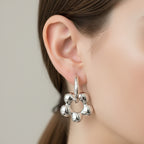 Pair of silver hoop earrings on a white background