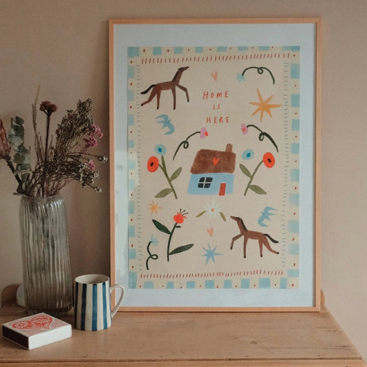 Framed artwork with decorative elements on a wooden surface