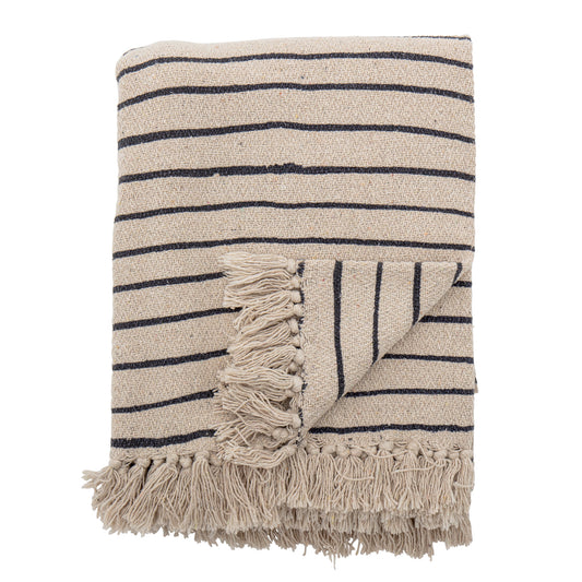 Bloominville Eia Recycled Cotton Throw in natural and black pin stripe displayed on a white background with a corner turned over to show the ruffled tufts.