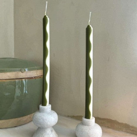 Pigmalion London Set of 2 Dinner Candles in Olive Green and Cream showcasing a wavy design from top to bottom.  Packaged in a white box with 2 windows showing the colour of the candles.