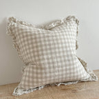 Ellenvale Ruffled Edged Linen Cushion Cover in Natural Gingham displayed on a bench against a white wall.