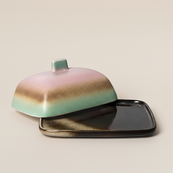 Ceramic butter dish with a gradient design on a beige background