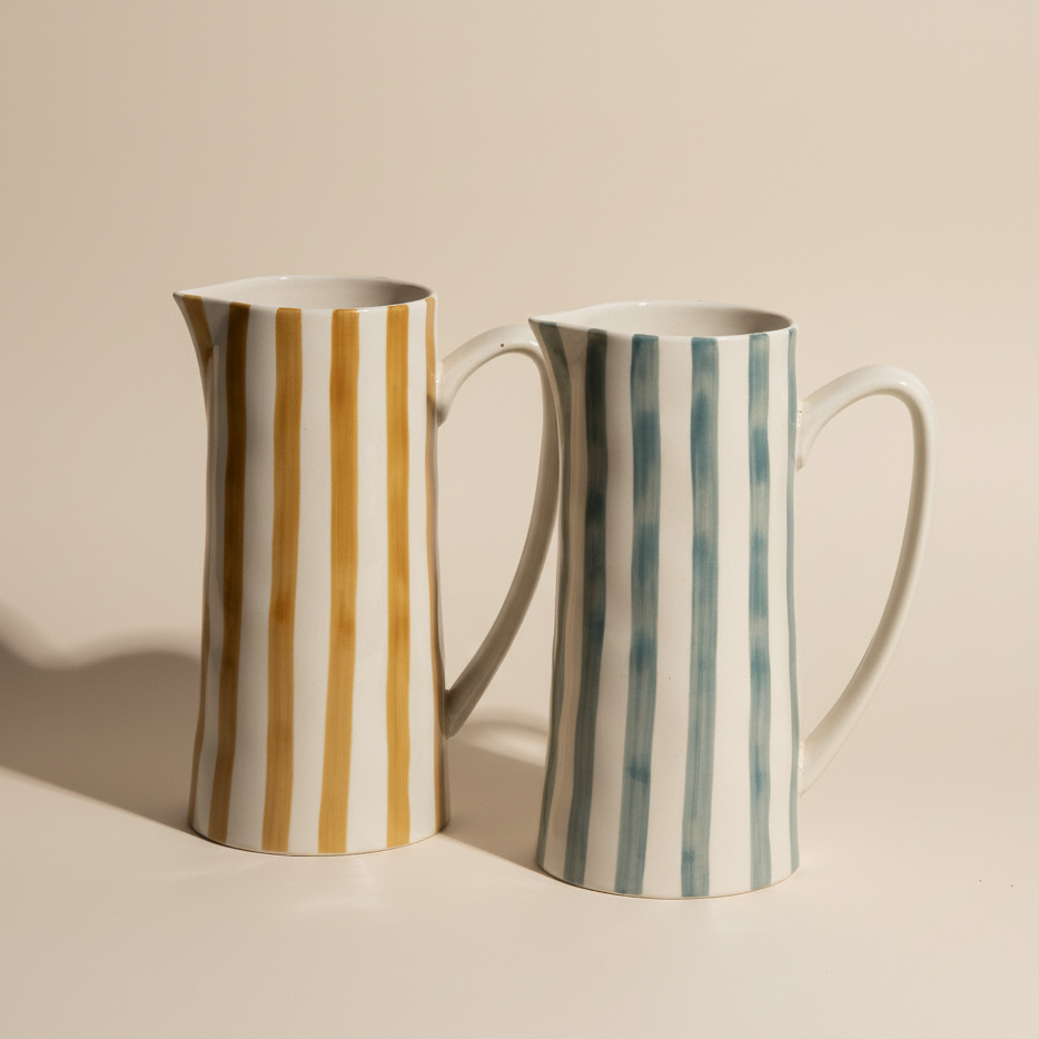 Two ceramic mugs with striped patterns on a beige background