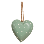 A green heart-shaped wooden decoration with white polka dots and a wooden rope hanging at the top.