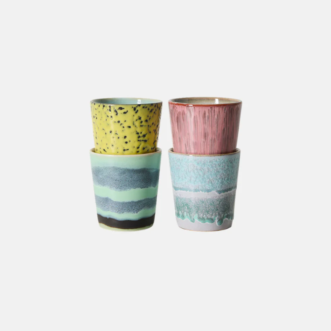 Two pairs of stacked ceramic cups with textured, hand-painted patterns in yellow, pink, blue, and green on a light gray background.