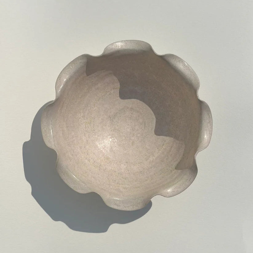 Decorative stone object with a textured surface on a plain background