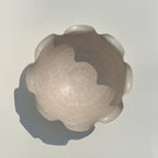 Decorative stone object with a textured surface on a plain background