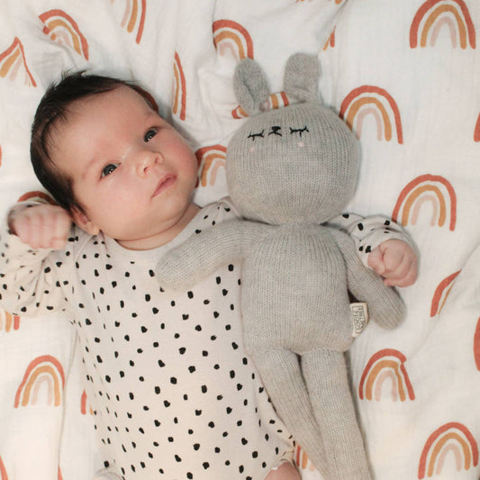 Lenny the Handmade Bunny laying next to a baby