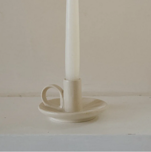 Cream candle holder called 'wee willy winky' displayed with a white candle inside on a white and cream background 
