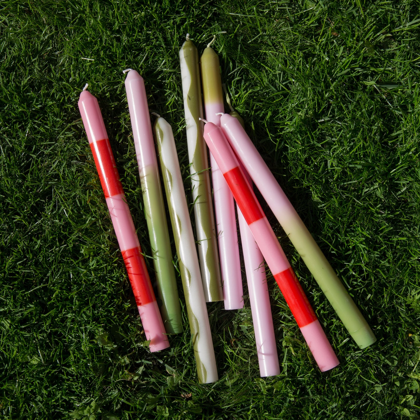 Pygmalion eco friendly dinner candles displayed lying on the grass 