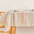 SG hogar table cloth with multi coloured stripe pattern, displayed on a kitchen table 