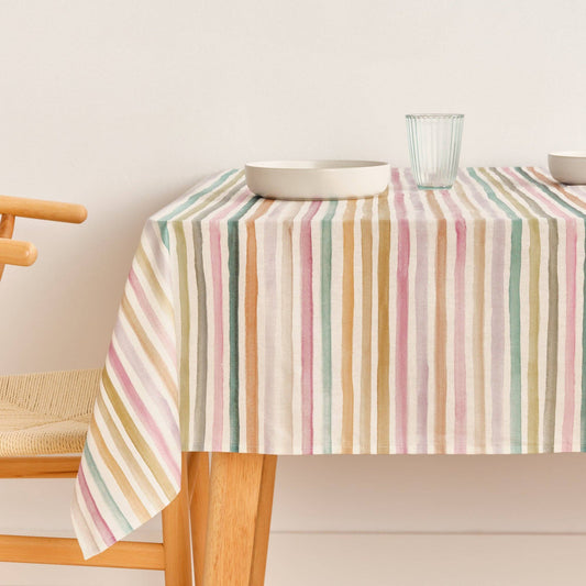 SG hogar table cloth with multi coloured stripe pattern, displayed on a kitchen table 