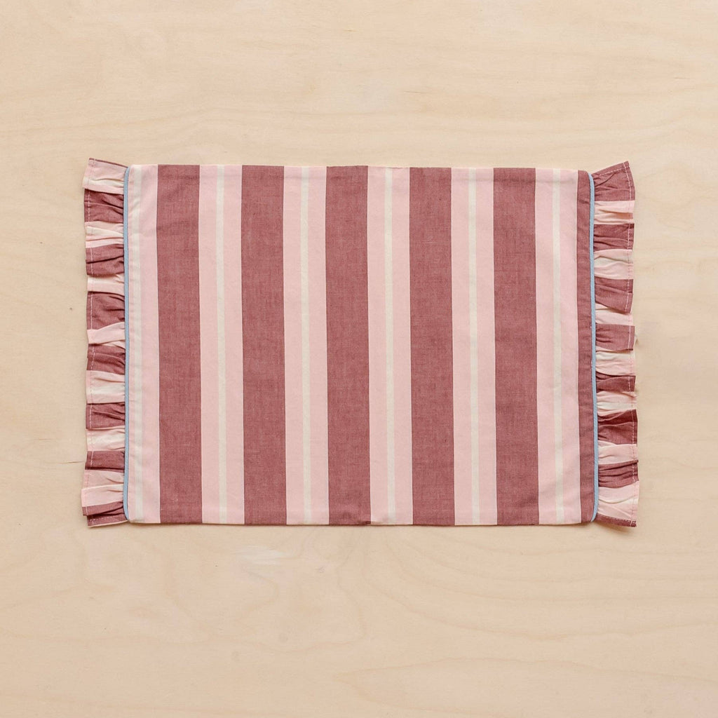 TBCo Cotton Placemats in Red and Pink Stripe with Frilly Edge laid flat on a pink background.