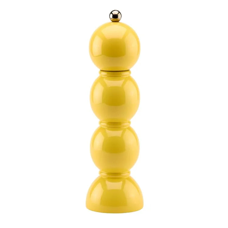 Yellow pepper grinder on a white background