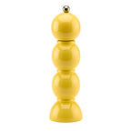 Yellow pepper grinder on a white background