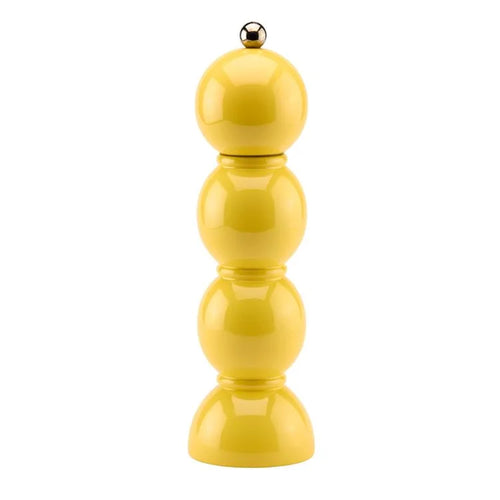 Yellow pepper grinder on a white background