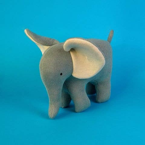 Gray elephant plush toy on a blue background