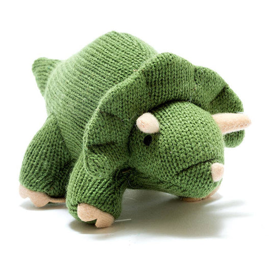 Green knitted dinosaur toy on a white background