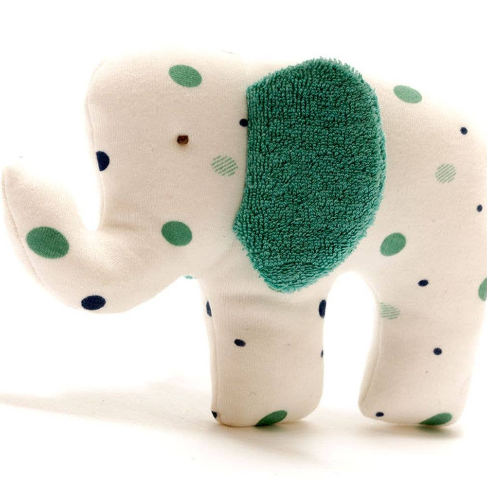 Stuffed elephant toy with green polka dots on a white background
