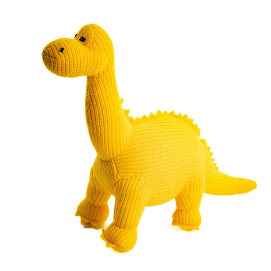 Yellow knitted dinosaur toy on a white background