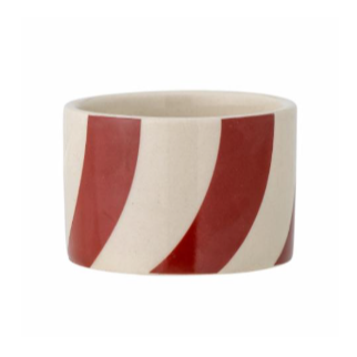 A cylindrical stoneware candle holder with bright red and white stripes.