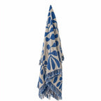 Blue and beige patterned throw with fringes on a white background