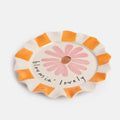 Scalloped edged plate with orange stripes and a pink echinacea flower 