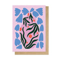 Greeting card with blue floral design on a pink background